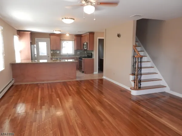 a view of kitchen and hall with wooden floor