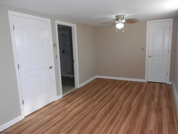 an empty room with wooden floor