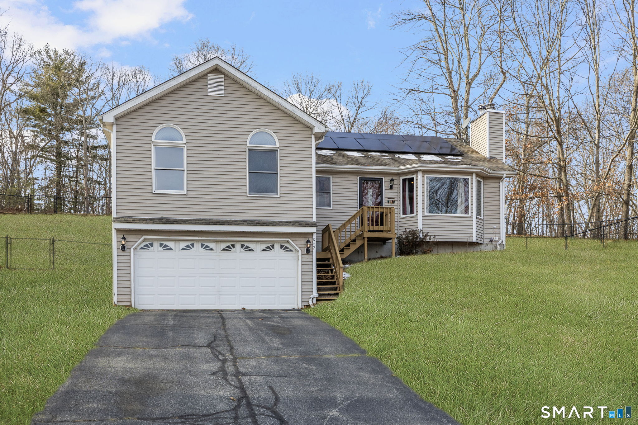 a front view of a house with a garden and yard