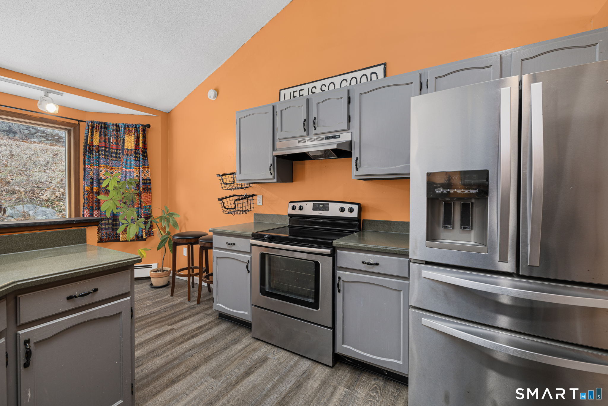 89 Kinney Hill Road Plainfield, CT 06374 - Photo 4 of 33 a kitchen with stainless steel appliances white cabinets and a stove top oven