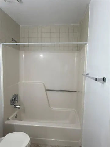 a bathroom with a shower and a toilet