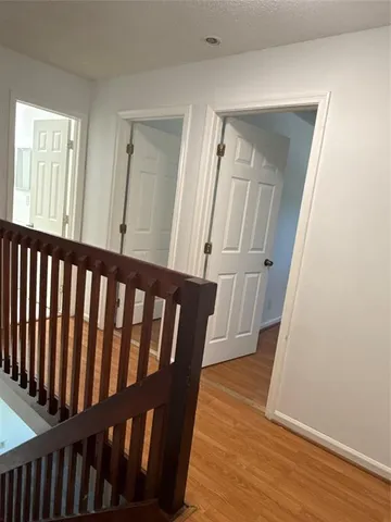 a view of staircase with wooden floor and railing