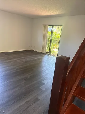a view of wooden floor and windows in a room