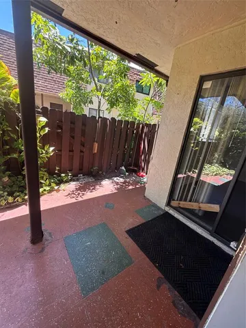 a view of backyard with green space and wooden fence