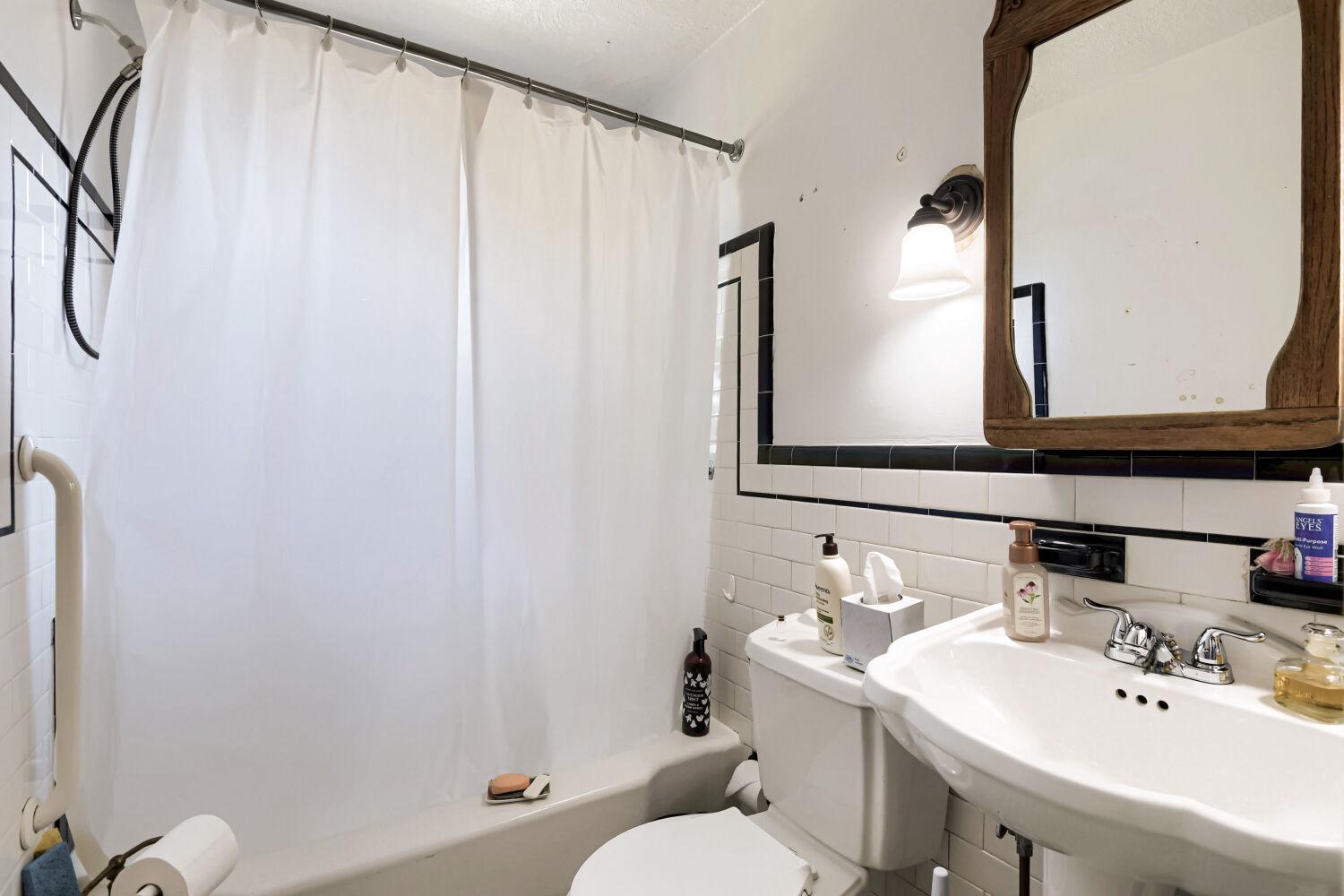 217 Doris Avenue Baltimore, MD 21225 - Photo 10 of 16 a bathroom with a sink a toilet and mirror