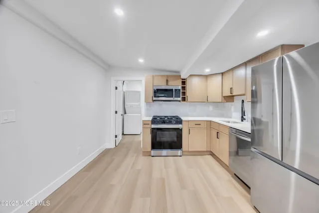 a bathroom with a sink toilet a mirror and window
