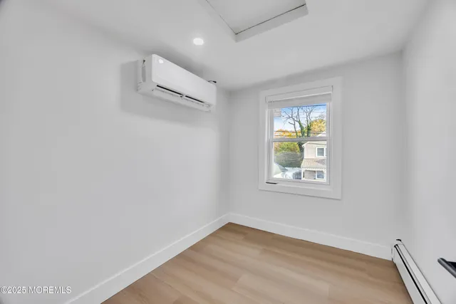 a view of room with window and wooden floor