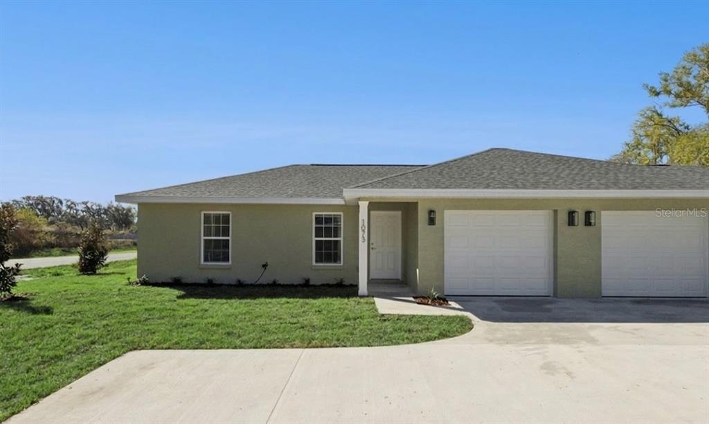 a view of a house with a small yard and a large window