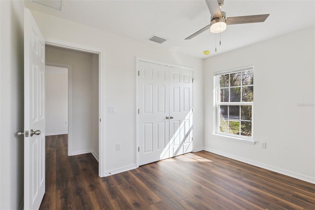 1073 North Rockingham Avenue Tavares, FL 32778 - Photo 11 of 17 wooden floor in an empty room with a window