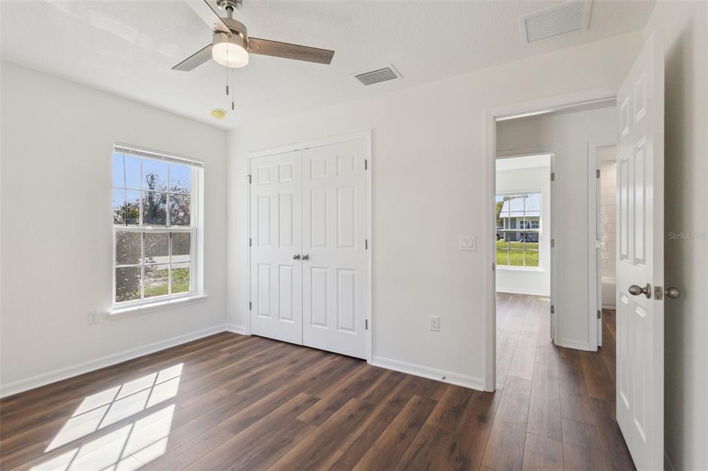 1073 North Rockingham Avenue Tavares, FL 32778 - Photo 13 of 17 wooden floor in an empty room with a window