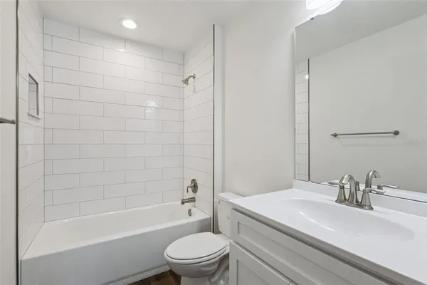 a bathroom with a sink a toilet and a bathtub