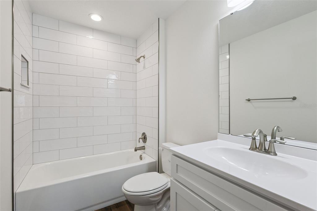 1073 North Rockingham Avenue Tavares, FL 32778 - Photo 15 of 17 a bathroom with a sink a toilet and a bathtub