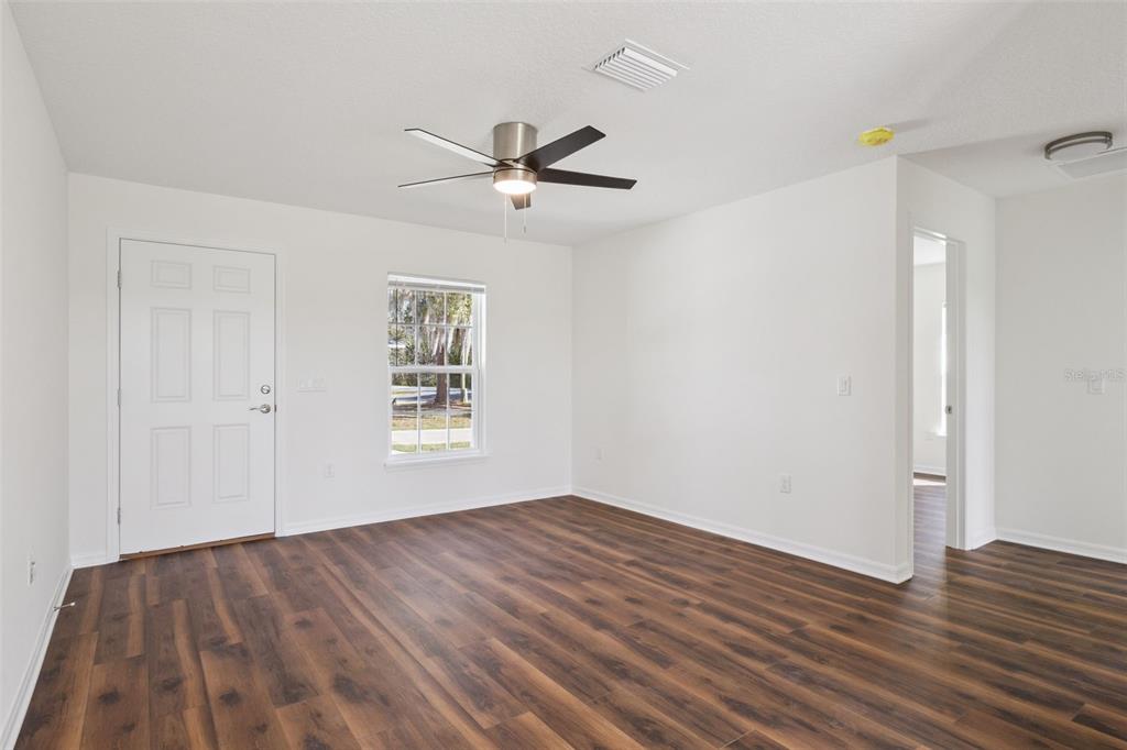 1073 North Rockingham Avenue Tavares, FL 32778 - Photo 2 of 17 a view of empty room with wooden floor and fan