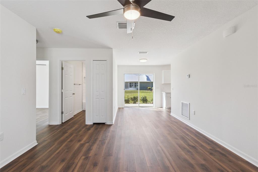 1073 North Rockingham Avenue Tavares, FL 32778 - Photo 4 of 17 wooden floor in an empty room with a window
