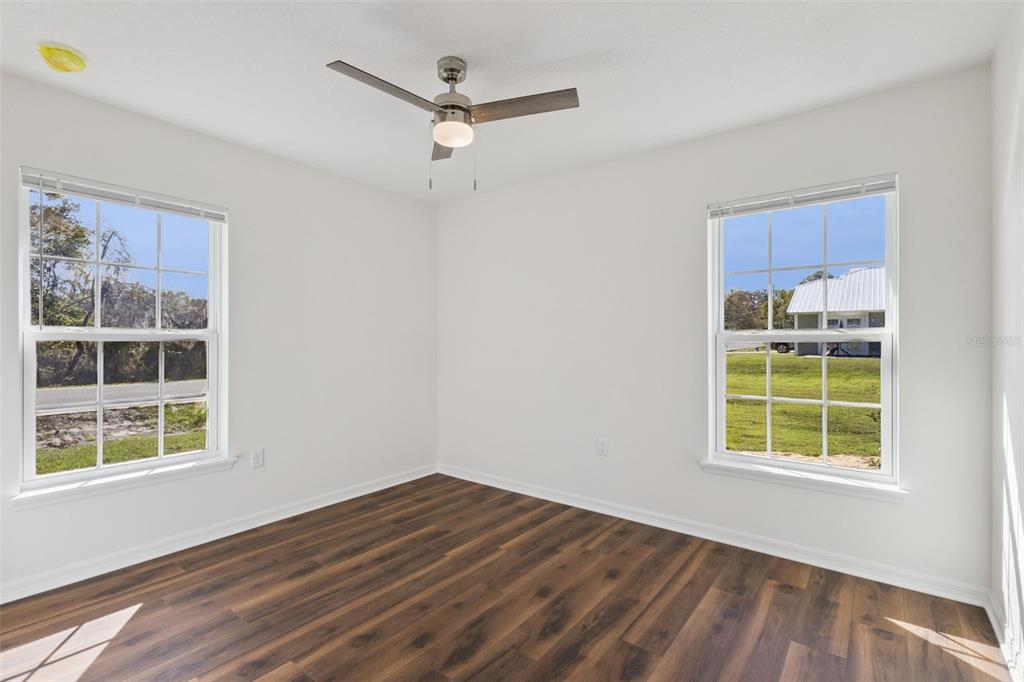 1073 North Rockingham Avenue Tavares, FL 32778 - Photo 10 of 17 an empty room with a window and wooden floor