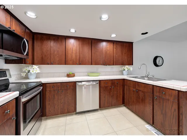a kitchen with a sink a stove and cabinets