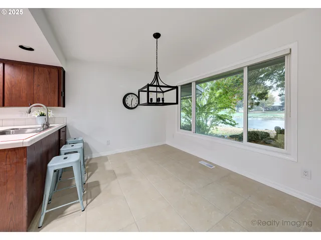 a dining room with a window and furniture