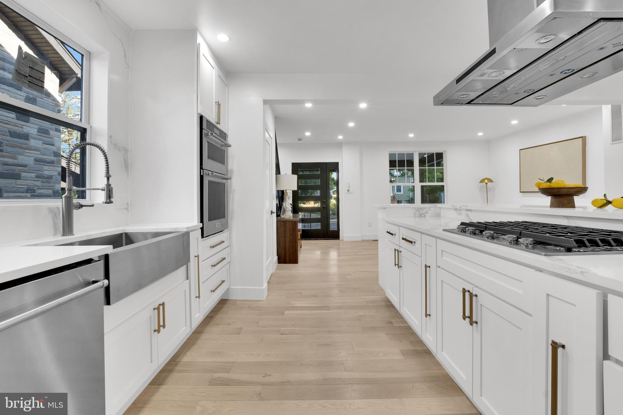 1312 Franklin Street Northeast Washington, DC 20017 - Photo 12 of 42 a large kitchen with stainless steel appliances lots of white cabinets
