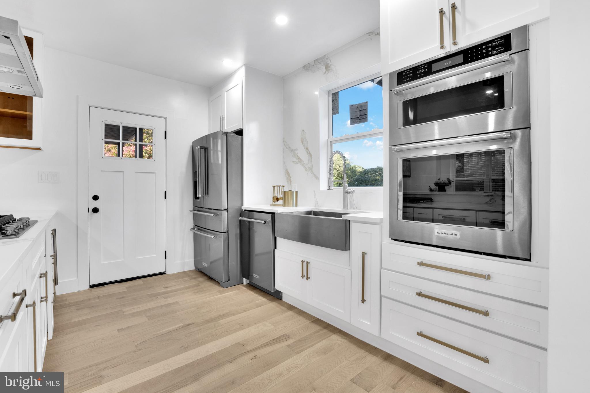 1312 Franklin Street Northeast Washington, DC 20017 - Photo 15 of 42 a kitchen with stainless steel appliances a refrigerator stove and cabinets