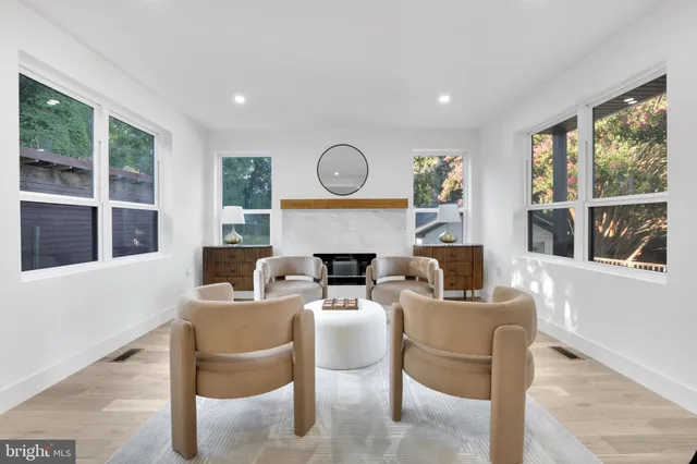 a dining room with furniture a fireplace and wooden floor