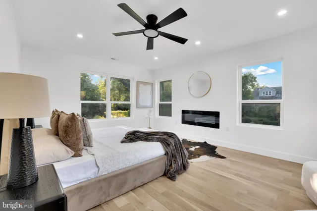 a bed room with a bed mirror and window
