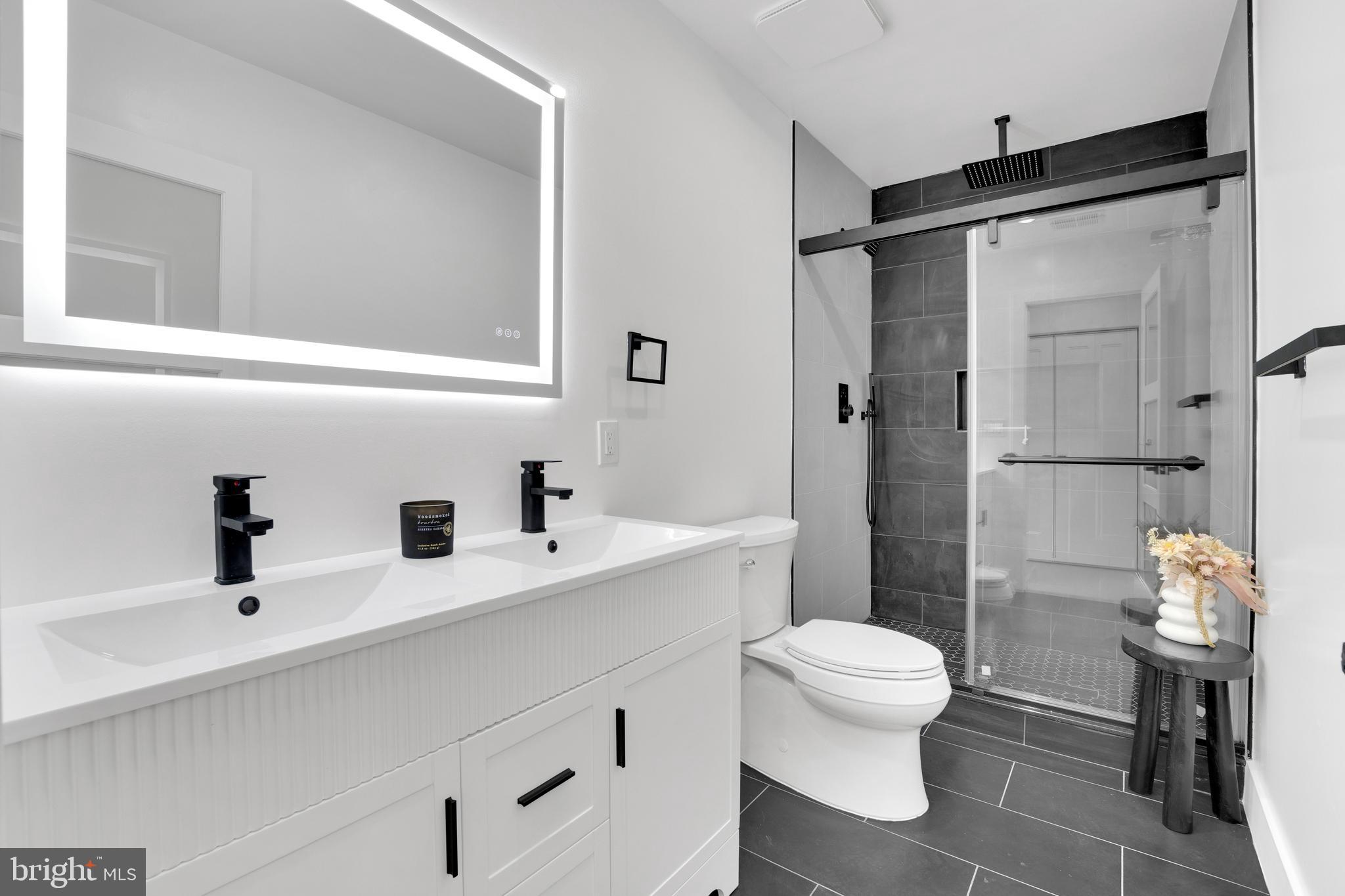 1312 Franklin Street Northeast Washington, DC 20017 - Photo 26 of 42 a bathroom with a sink toilet a mirror and shower