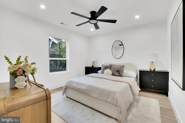a bedroom with a bed and ceiling fan