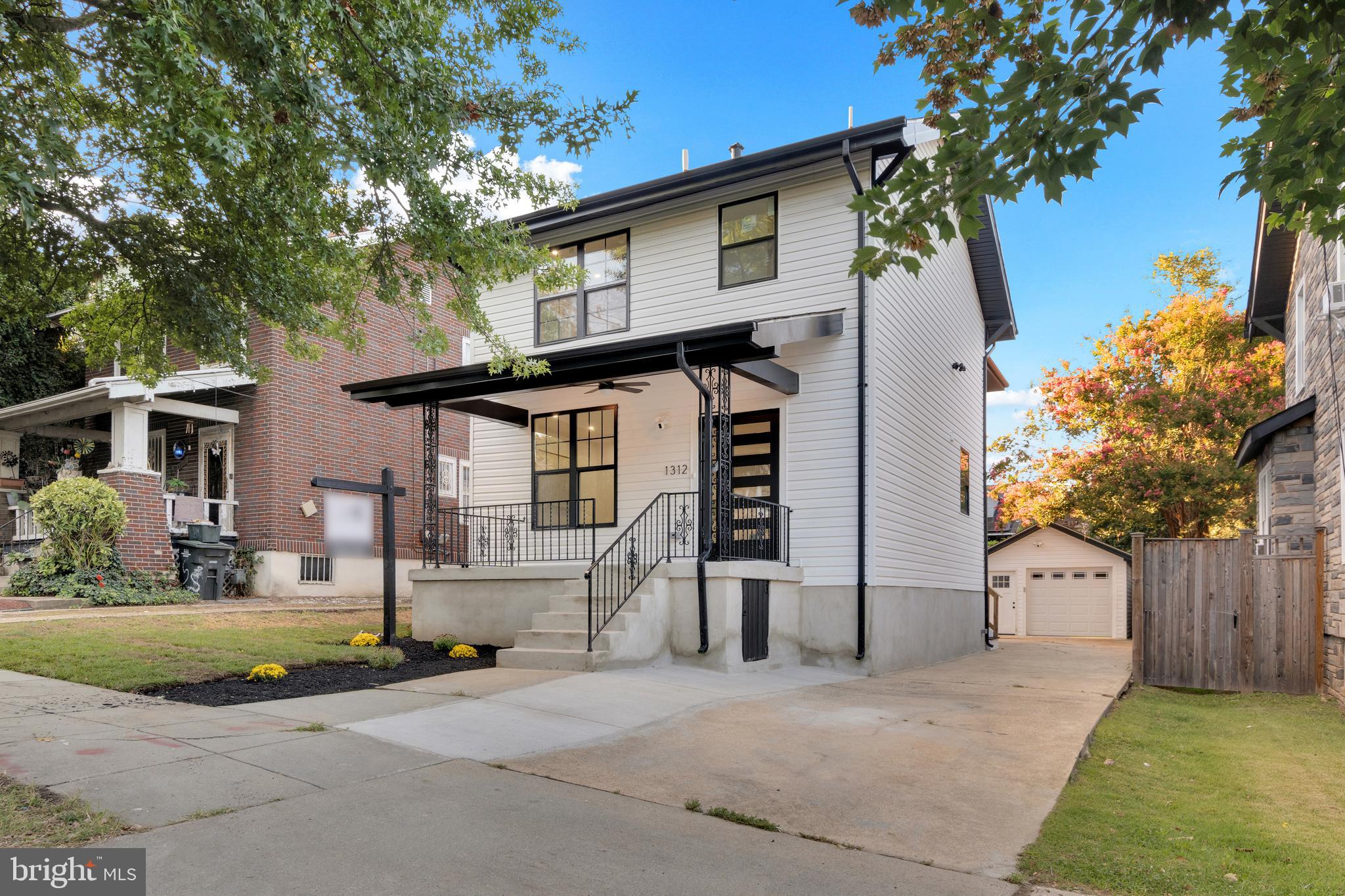 1312 Franklin Street Northeast Washington, DC 20017 - Photo 3 of 42 a front view of a house with a yard and garage