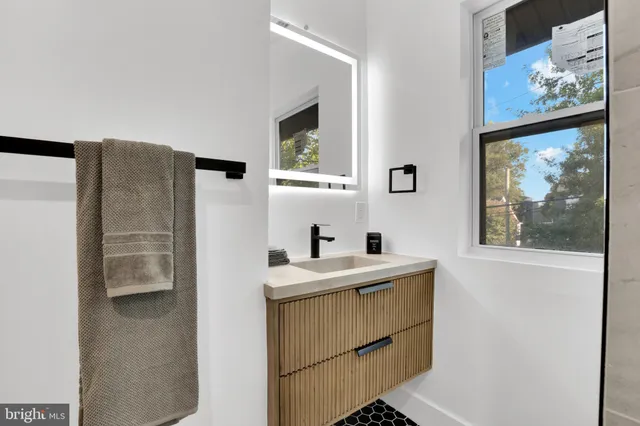 a bathroom with a sink mirror and a vanity