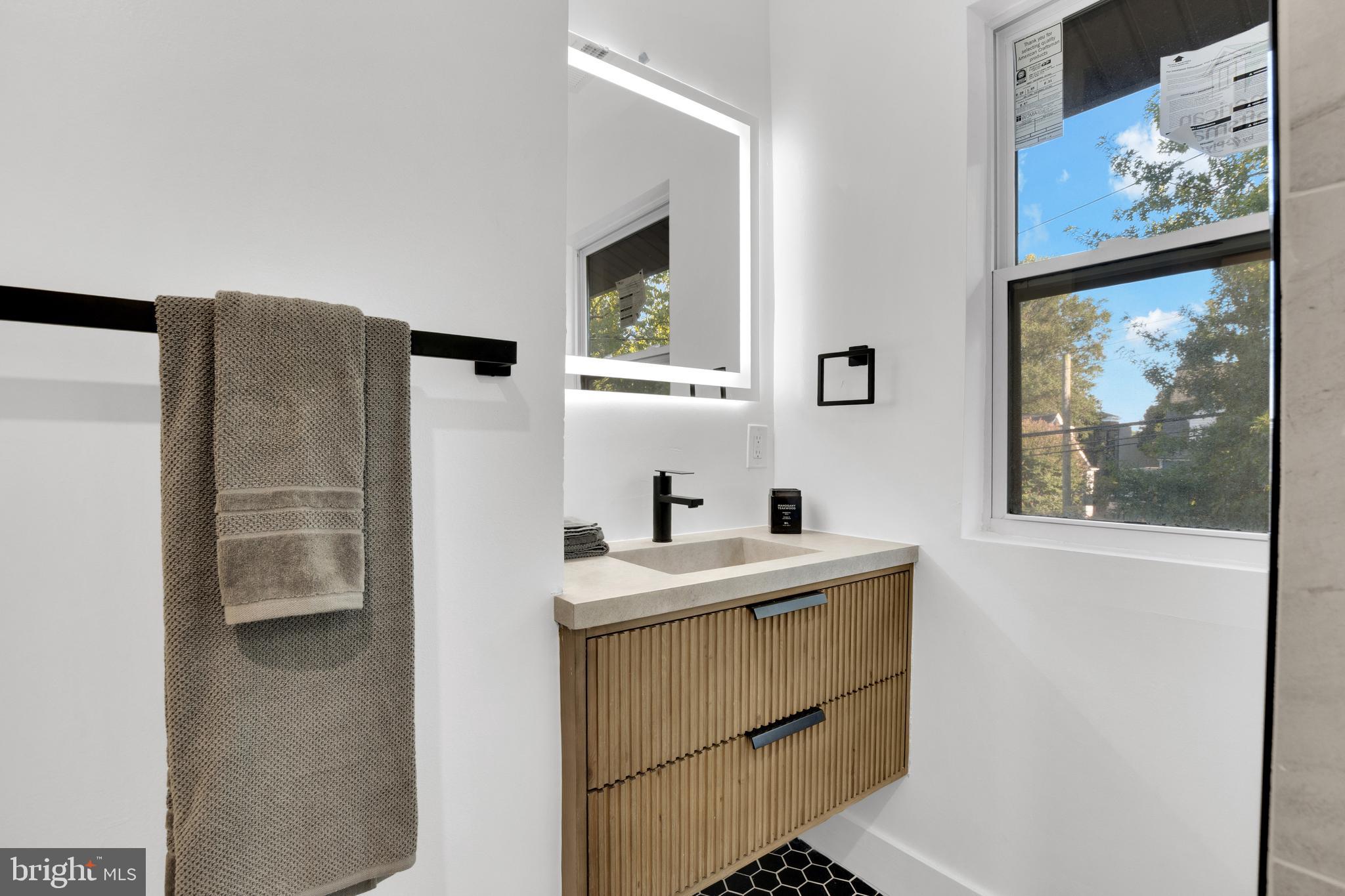 1312 Franklin Street Northeast Washington, DC 20017 - Photo 31 of 42 a bathroom with a sink mirror and a vanity