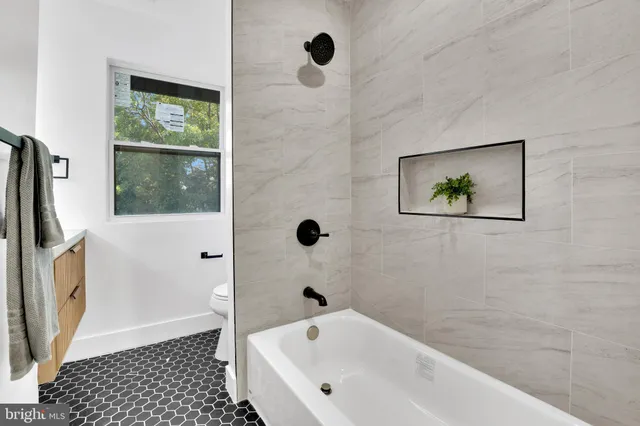 a bathroom with a bathtub and a shower