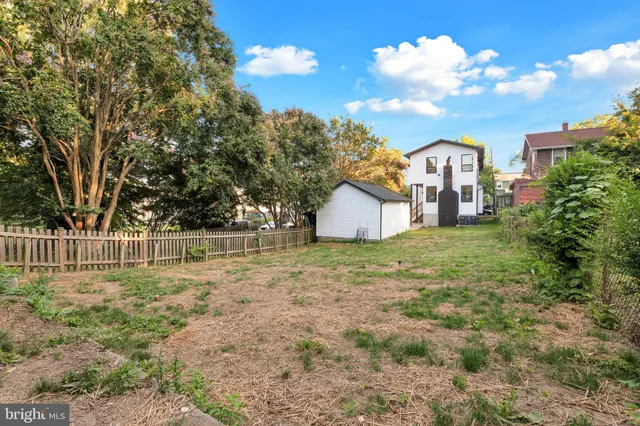 a view of a house with a yard and garage