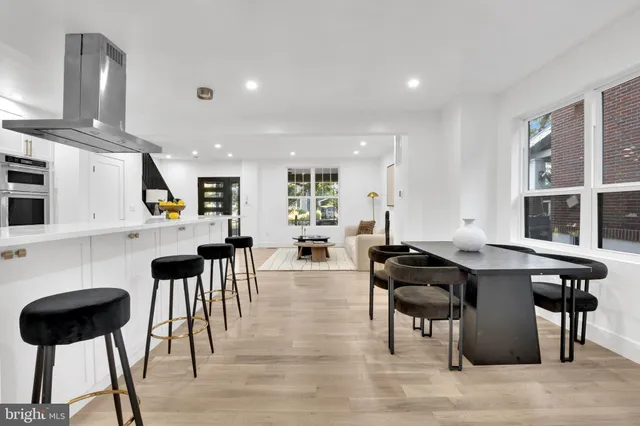 a kitchen with stainless steel appliances kitchen island granite countertop a table and chairs