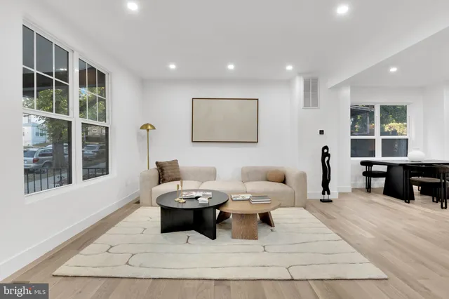 a living room with furniture a window and glass door