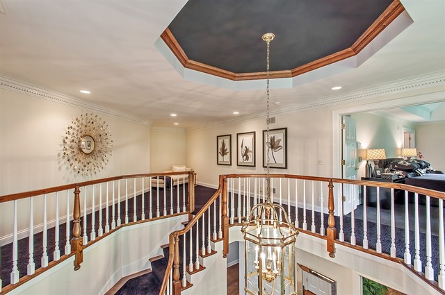 610 South Ridge Road Lake Forest, IL 60045 - Photo 13 of 24 a view of staircase with railing and a chandelier
