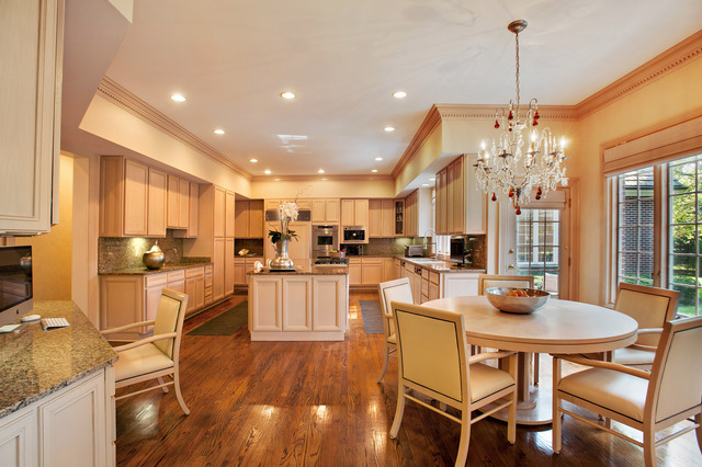 610 South Ridge Road Lake Forest, IL 60045 - Photo 6 of 24 a room with stainless steel appliances kitchen island granite countertop a dining table chairs and white cabinets