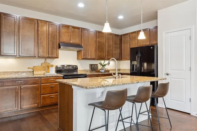 a kitchen with a stove a sink and cabinets