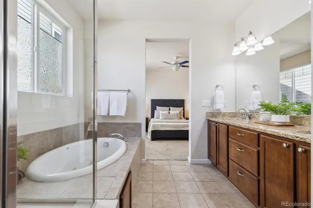 a en suite spacious bathroom with a tub sink and mirror