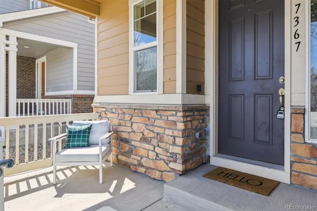 a view of front door of house with stairs