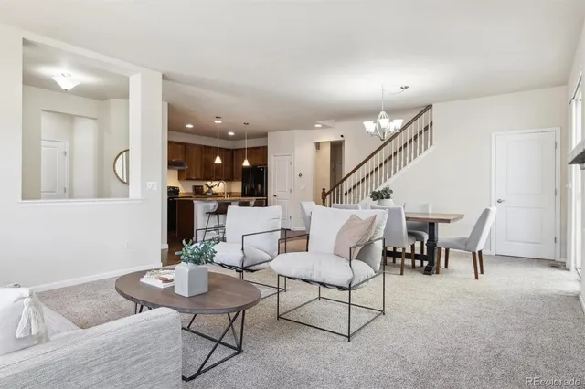 a living room with furniture and kitchen view