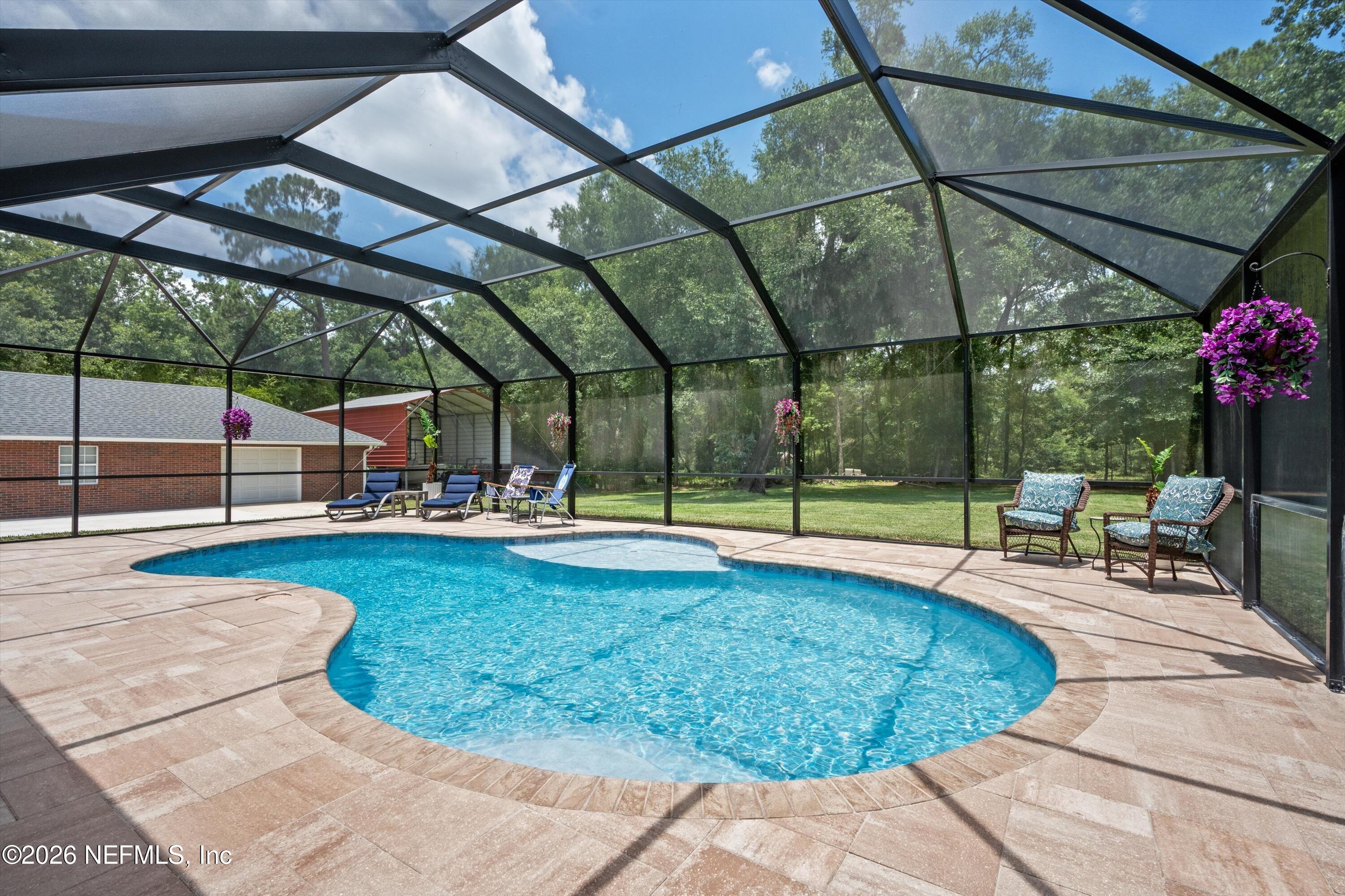 5566 Don Manuel Road Elkton, FL 32033 - Photo 35 of 47 a view of a swimming pool with a patio