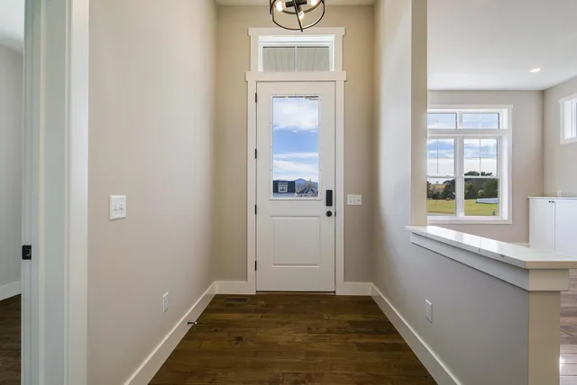 a kitchen with a stove and a wooden floor