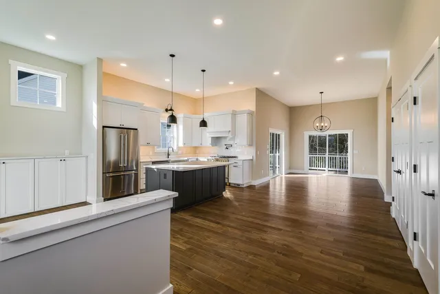 a view of an empty room with a window and fireplace