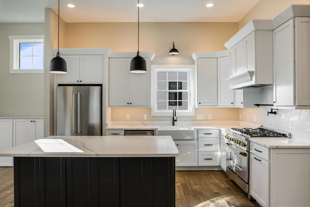 a view of an empty room with a window and fireplace