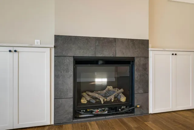 a view of a room with wooden floor and a window