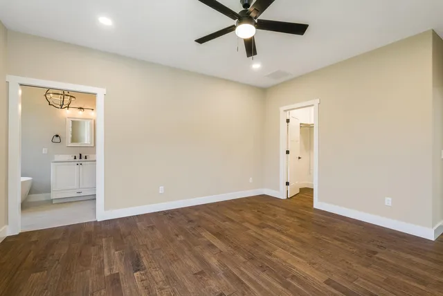 a view of a livingroom with an empty space and kitchen space