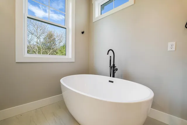 a view of room with wooden floor and fan