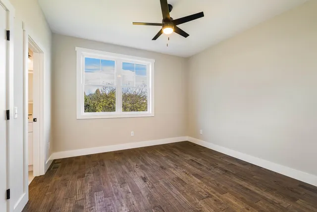 a backyard of a house with barbeque oven and plants