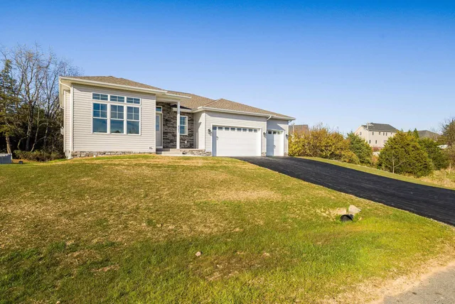 a kitchen with stainless steel appliances a sink a stove a refrigerator and cabinets