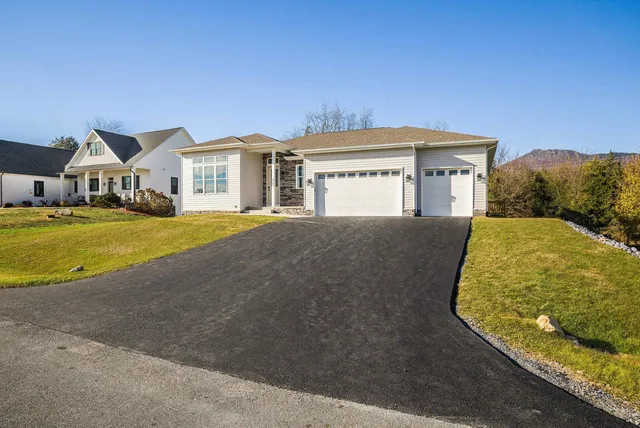 a kitchen with stainless steel appliances a stove a sink a refrigerator and cabinets